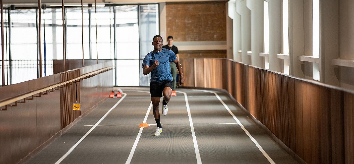 A student run down the track at the Powerhouse in an race.